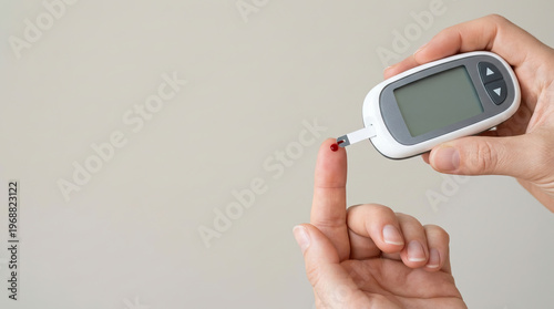 Blood glucose meter test strip blood drop finger prick diabetes monitoring health care medical device close up hand checking blood sugar glucose level diabetes management personal health medical