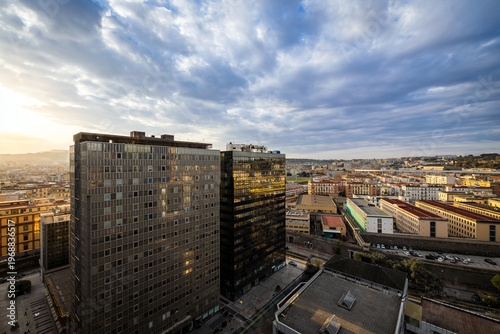 Contrast between modern office buildings and residential districts in Naples.