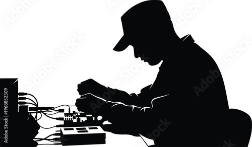 Silhouette of a technician working on complex electronic circuit board repairs