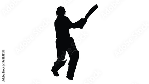 Silhouette of a cricket batsman in action poised to hit the ball