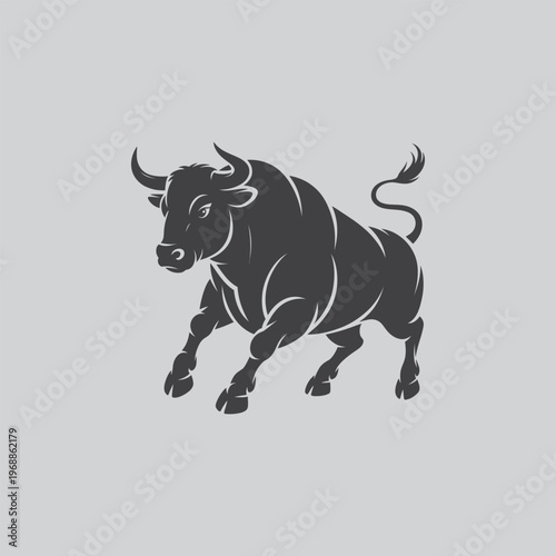 Dark silhouette of a charging bull on a grey background with the image captures