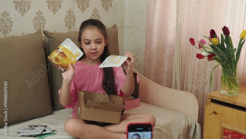 A beauty blogger, a girl dressed in a pink T-shirt, applies eye patches, films videos about her daily skincare routine, and reviews cosmetic products on social media. She films the videos on her phone