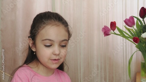 A beauty blogger, a girl dressed in a pink T-shirt, applies eye patches, films videos about her daily skincare routine, and reviews cosmetic products on social media. She films the videos on her phone