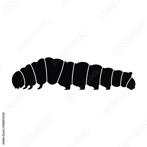 A caterpillar crawls slowly on a leaf in a garden environment