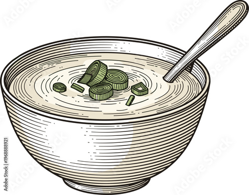 A bowl of creamy soup with olives and a spoon in it