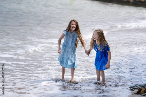 Girls playing with the waves