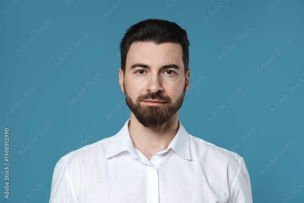 Obraz premium Portrait of handsome man on light blue background