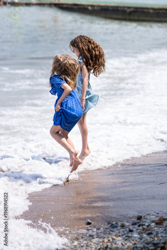 Girls playing with the waves
