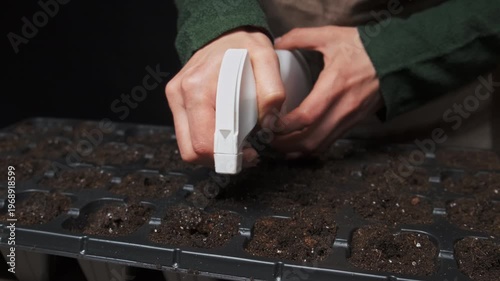 Caucasian Greenhouse Technician Using Handheld Seeder Device, Steady Grip And Controlled Trigger Place Uniform