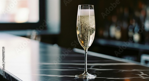 Elegant champagne flute on modern black marble bar in upscale setting