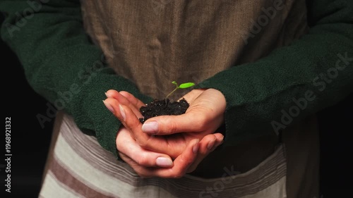 Hands Holding Soil With Tiny Sprout Closeup White Woman Gardener Wearing Apron Gently Cradling Seedling
