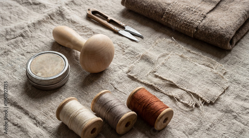 Mending clothes with linen thread and wooden darning mushroom. Manual textile repair to extend garment life. Zero waste fashion concept and sustainable lifestyle for eco friendly mending.