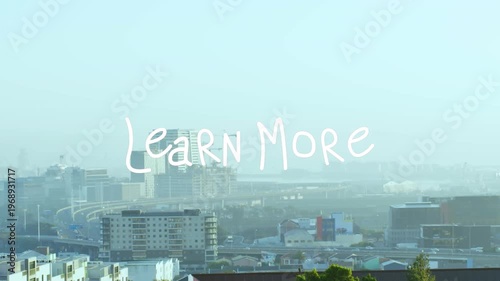 Animation of learn more text banner against aerial view of cityscape