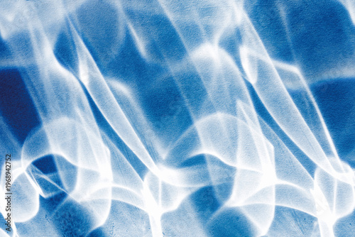 Vászonkép Abstract blue background featuring bright glowing light caustics, ideal for modern digital design, ethereal backdrops, creative artistic wallpaper projects, overlays