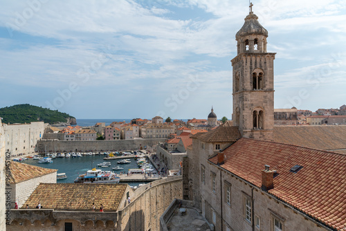 Картината върху платно Panoramic view of Dubrovnik old town rooftops and bell tower with harbor and Adr