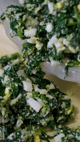 Making spinach pie Step-by-step video set cutting ingredients, rolling out dough, simmering spinach, adding eggs, baking, cutting the finished pie, the full recipe