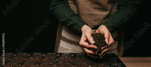 Hands Holding Rich Compost Soil, Tactile View Of Dark Loam With Visible Organic Texture And Moisture, Focus