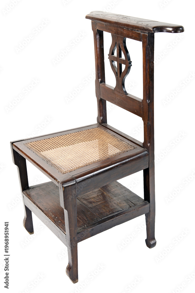 Εκτύπωση καμβά Antique wooden prie-dieu prayer chair with a woven cane seat, featuring a carved cross backrest and a bottom shelf for books