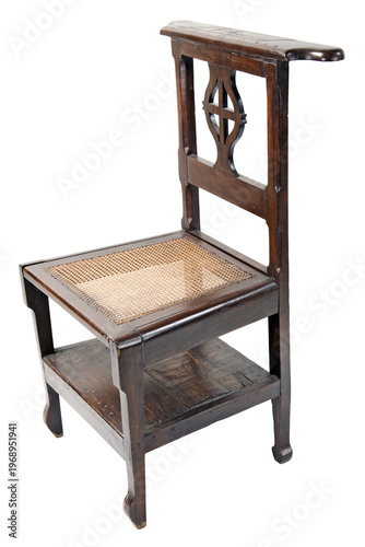Φωτογραφία Antique wooden prie-dieu prayer chair with a woven cane seat, featuring a carved cross backrest and a bottom shelf for books