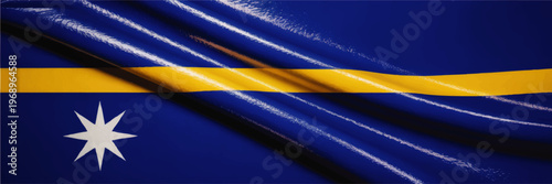 Waving Nauru national flag close up with glossy fabric texture, blue field, yellow equator stripe and white star