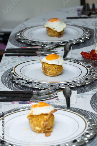 Three Ecuadorian green plantain bolones with eggs served on plates, ready to eat, traditional food