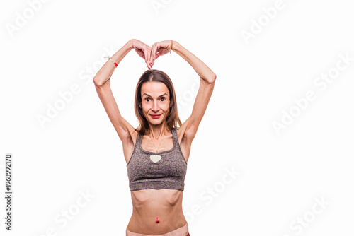 Woman showing heart shape with emaciated arms