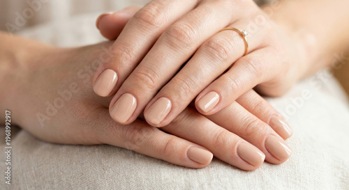 A close-up shot of a woman's hands with a perfect manicure.