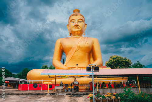 A golden Big Buddha with the blue sky and clouds background , South Asia