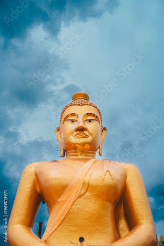 A golden Big Buddha with the blue sky and clouds background , South Asia