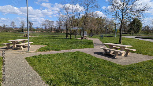 Picturesque Picnic Area with Concrete Tables and Benches in a Serene Park Setting