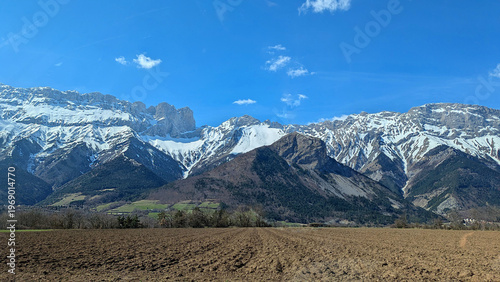Scenic Alpine Landscape Snow-Capped Mountains Against Blue Skies, Ideal for Outdoor Tourism