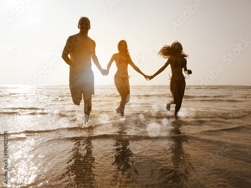 young teen playing and running on the beach