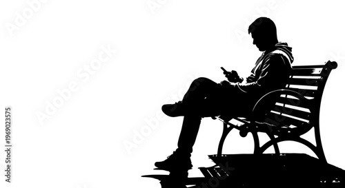 A person sits on a park bench reading a book in the city.