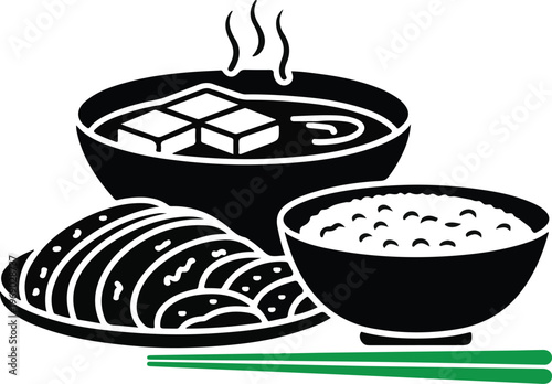 Traditional japanese meal with miso soup rice and sliced side dishes.