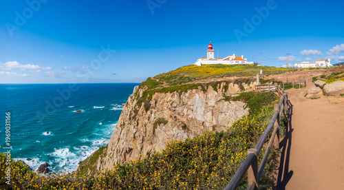 Cabo da Roca lighthouse on cliff above Atlantic ocean in Sintra, Lisbon district, Portugal. Most western point of continental Europe. Beautiful seascape on sunny day
