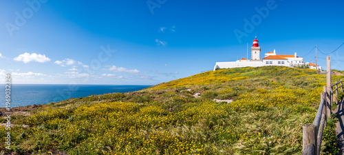 Cabo da Roca lighthouse on cliff above Atlantic ocean in Sintra, Lisbon district, Portugal. Most western point of continental Europe. Beautiful seascape on sunny day