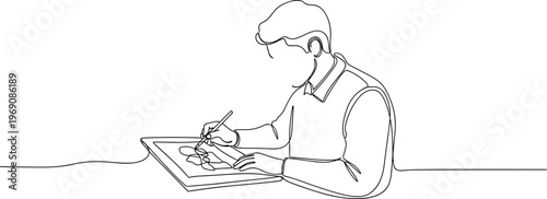 Man sitting and drawing on paper.