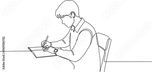 Young man writing on paper.