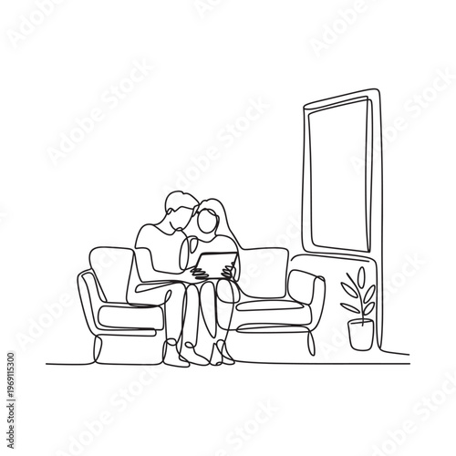 A couple sits closely together on a couch looking at a laptop