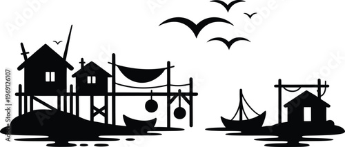 Silhouette fishing village with boats and birds flying over water