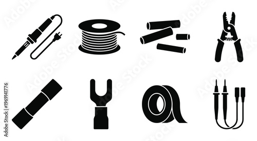 Collection of black electronic components and tools on gray background, soldering iron, wire spool, heat shrink tubes, wire cutters, connector, tape