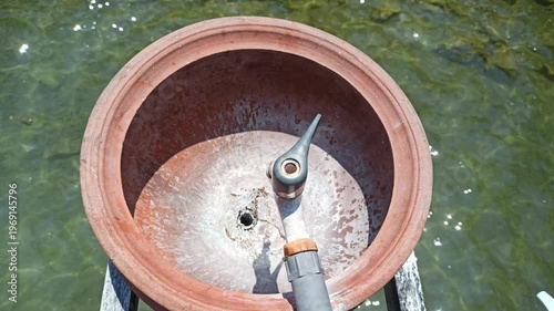 Wallpaper Mural A simple handwashing station using a clay jar, offering a traditional and natural way to maintain hygiene with an earthy and rustic aesthetic. Torontodigital.ca