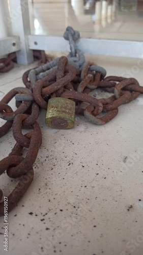 Wallpaper Mural A sturdy chain and padlock used for security, highlighting protection, safety, and reliable locking in a simple setting. Torontodigital.ca