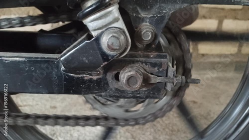 Wallpaper Mural A motorcycle chain on an underbone bike transfers engine power to the rear wheel, highlighting its function, durability, and role in smooth riding performance. Torontodigital.ca