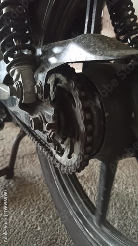 Wallpaper Mural A motorcycle chain on an underbone bike transfers engine power to the rear wheel, highlighting its function, durability, and role in smooth riding performance. Torontodigital.ca