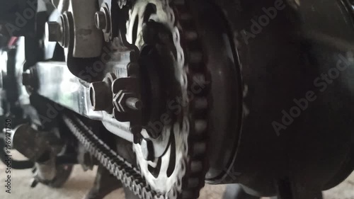 Wallpaper Mural A motorcycle chain on an underbone bike transfers engine power to the rear wheel, highlighting its function, durability, and role in smooth riding performance. Torontodigital.ca