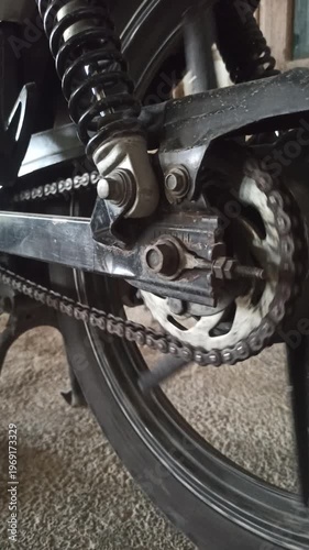 Wallpaper Mural A motorcycle chain on an underbone bike transfers engine power to the rear wheel, highlighting its function, durability, and role in smooth riding performance. Torontodigital.ca