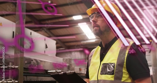 Worker holding tablet, reading data and doing factory safety check while magenta overlays moving
