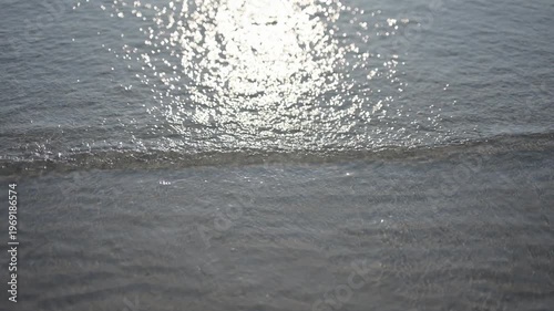 Sun reflecting on calm ocean waves
