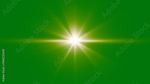 Bright lens flare effect on green screen background. golden light lens flare green screen alpha channel. Cinematic lens flare overlay. Shining star and light rays motion graphics on Green screen